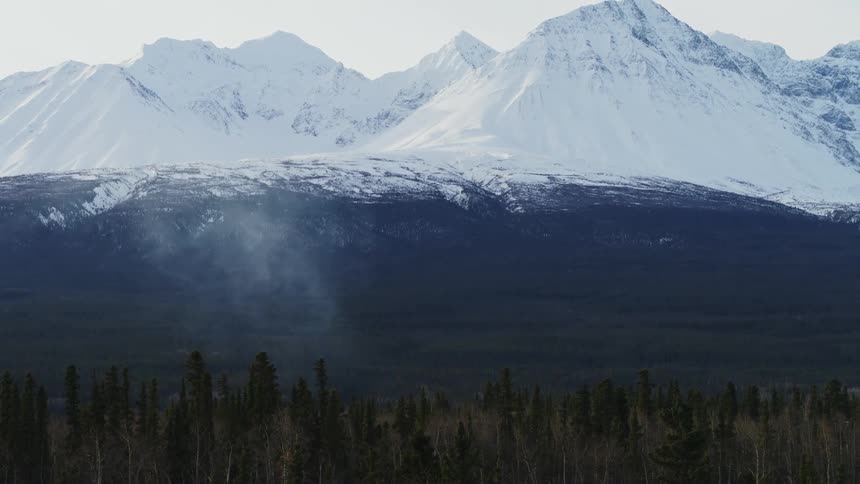 Snow covered mountains are displayed during winter