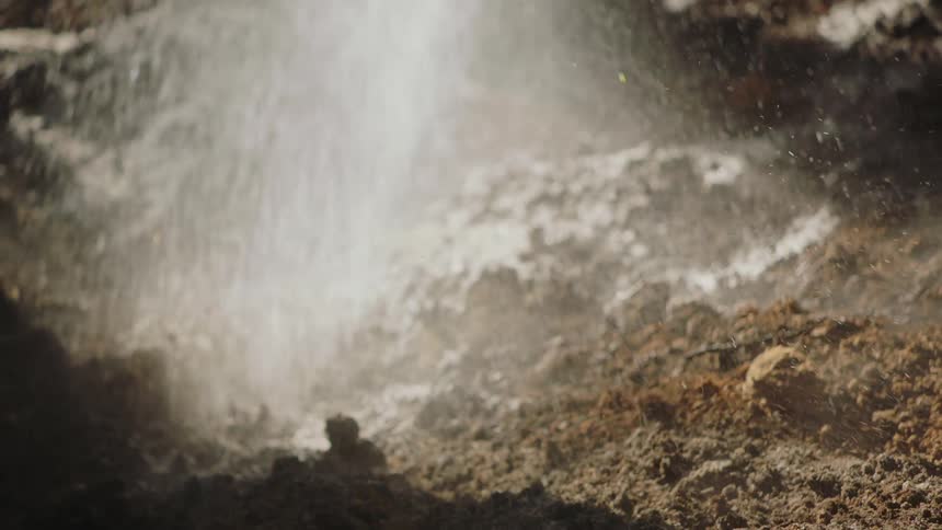 Water is sprayed on the dirt