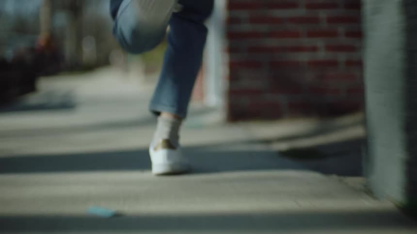 A person is running on the sidewalk