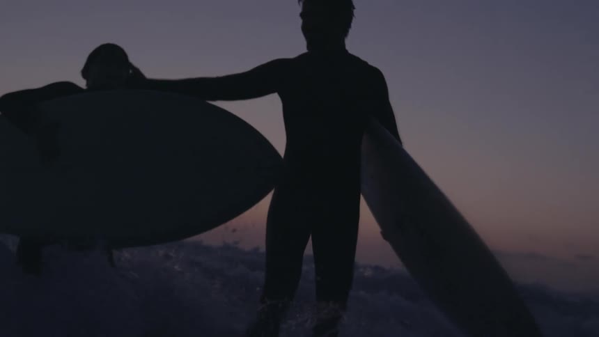 Father and son are surfing on ocean water