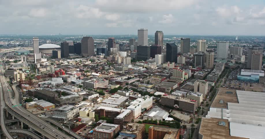 An aerial view of New Orleans downtown skyline including the iconic Crescent City Connection Bridge on a cloudy day