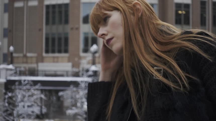 A woman looks up leaning on her hand