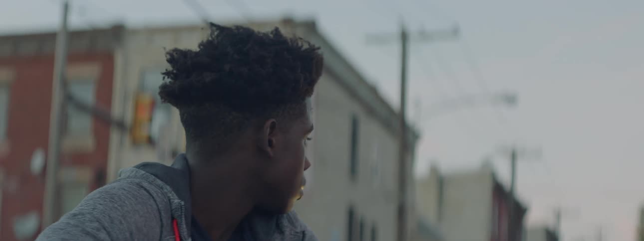A boy looks around on a cloudy day