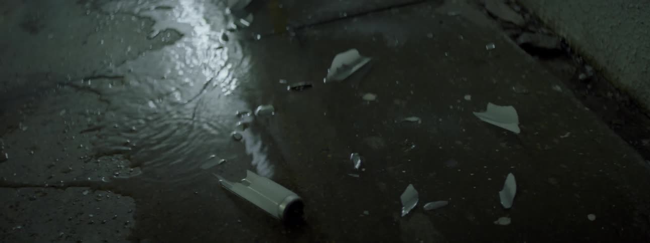 Broken light shards in a puddle of water