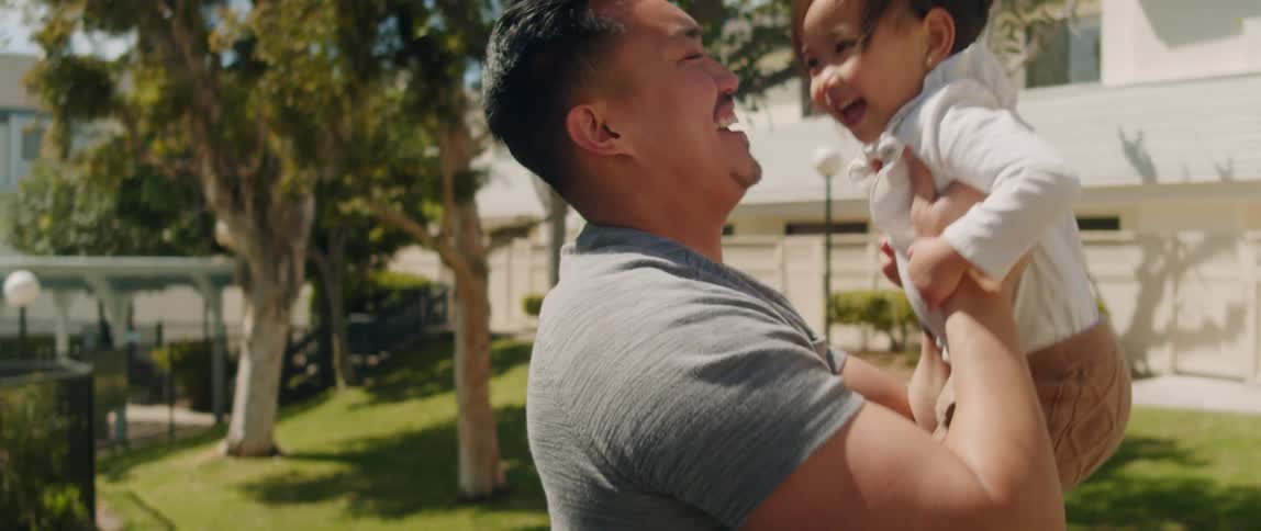 Happy father plays with his daughter on the playground