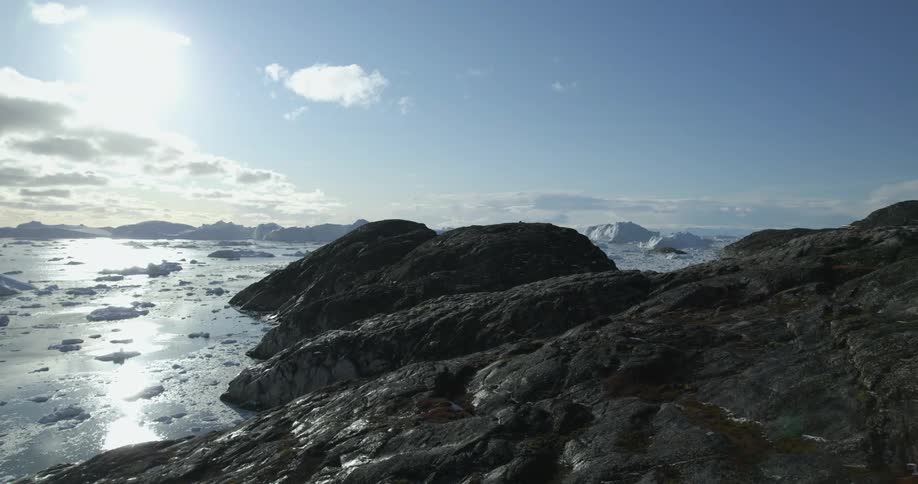Rocky terrain near the ocean on a partly cloudy day