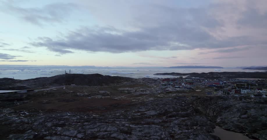 Aerial view of a coast near the ocean at dusk