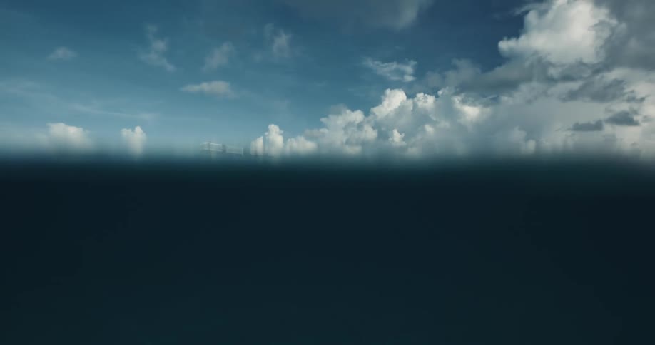 Seaplane moves across water near shore leaving a wake on a cloudy day