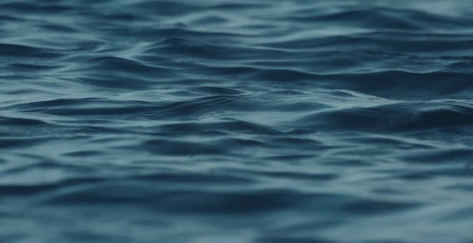 Light reflects on the water as it ripples and waves