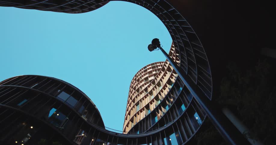 A straight up shot of an oddly shaped building with a cove style shape