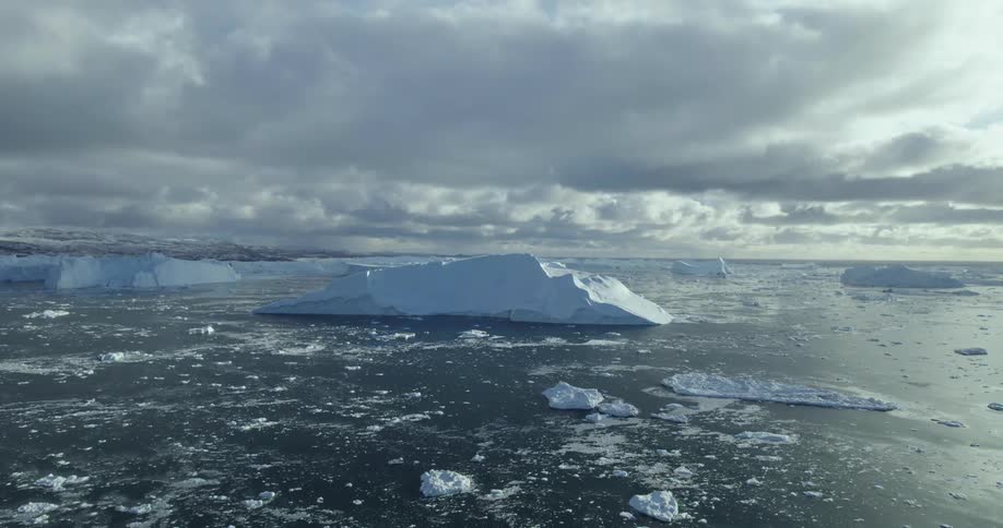 The snow is melting in the ocean during sunset