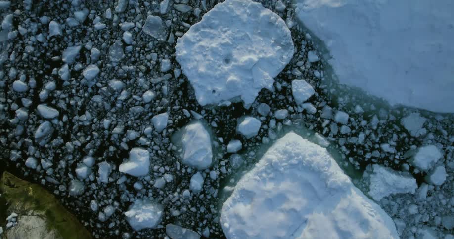 Birds eye view of frozen ocean during midday