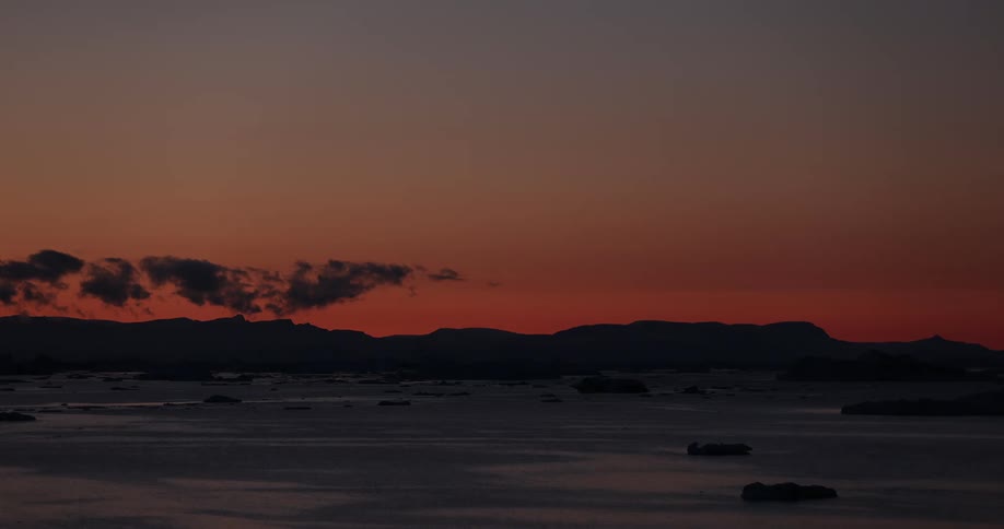 Traveling over the icy ocean water glacial landscape over timelapsed 24hour period