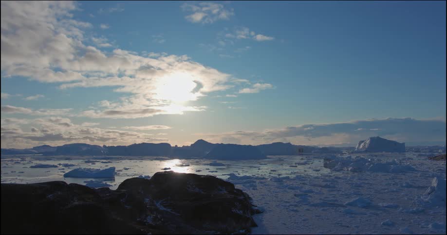 Snow is melting in the ocean water at dusk