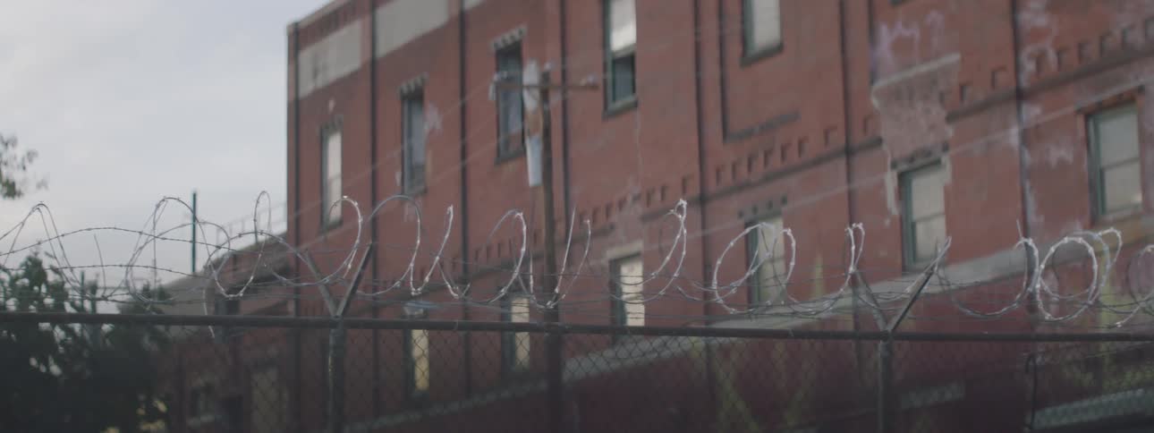 Barbed wire on top of a fence