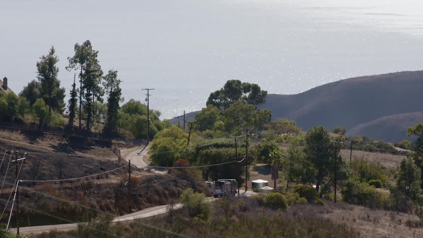 Fire truck drives uphill on country road