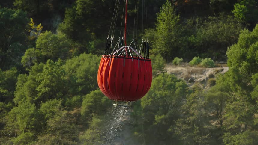 A balloon full of water is lifted in the air