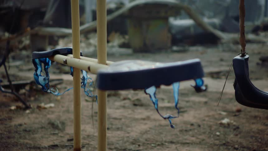 Close up of a swing set that is falling apart