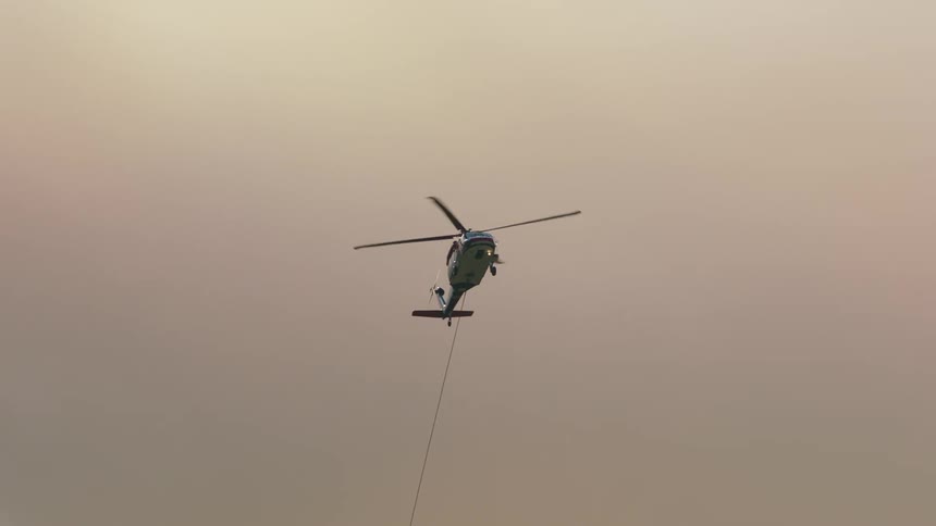 A rope is hanging from the helicopter