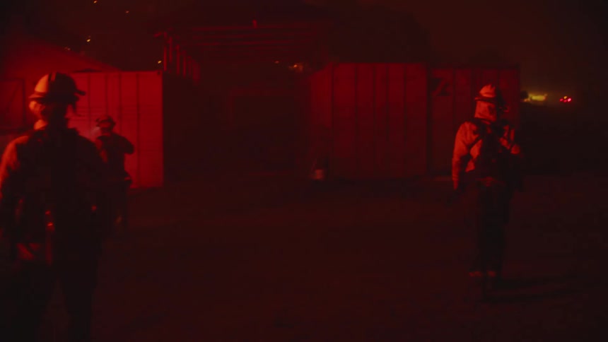 Fireman walk in the smoke at night