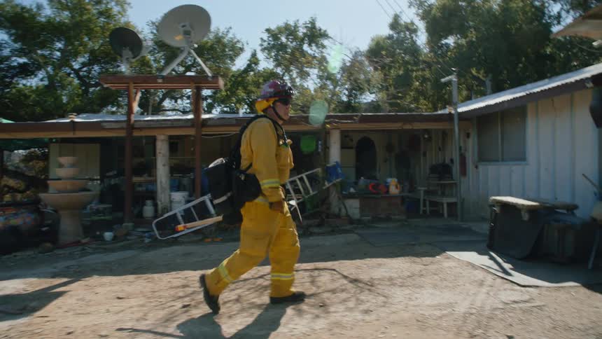 A firefighter walking outdoors