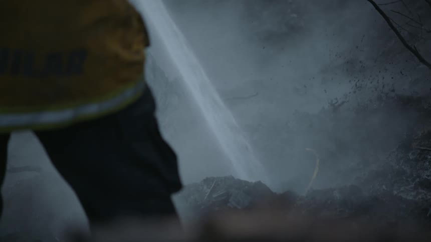 A fireman spraying water on a fire