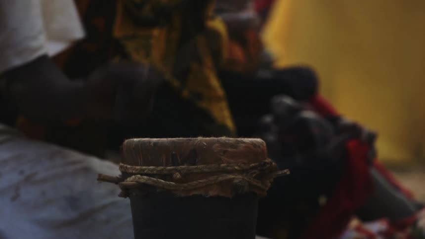 A person is playing a small drum