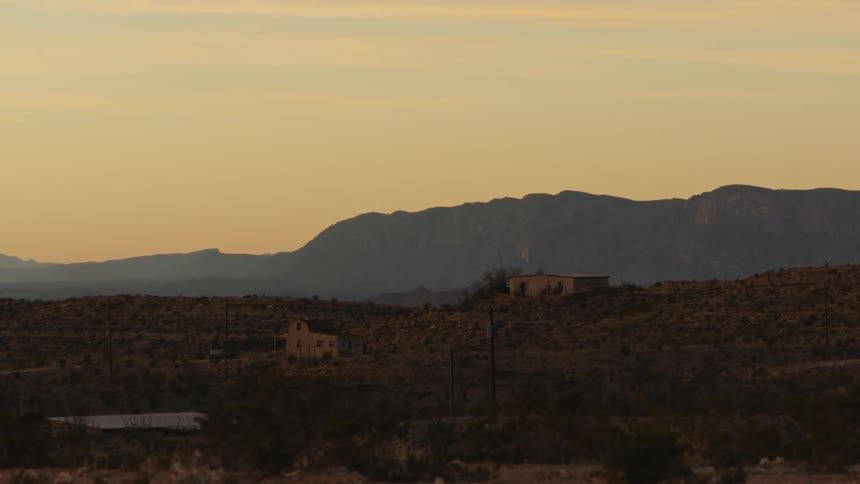 West Texas mountains at sunset with farmhouses on the horizon
