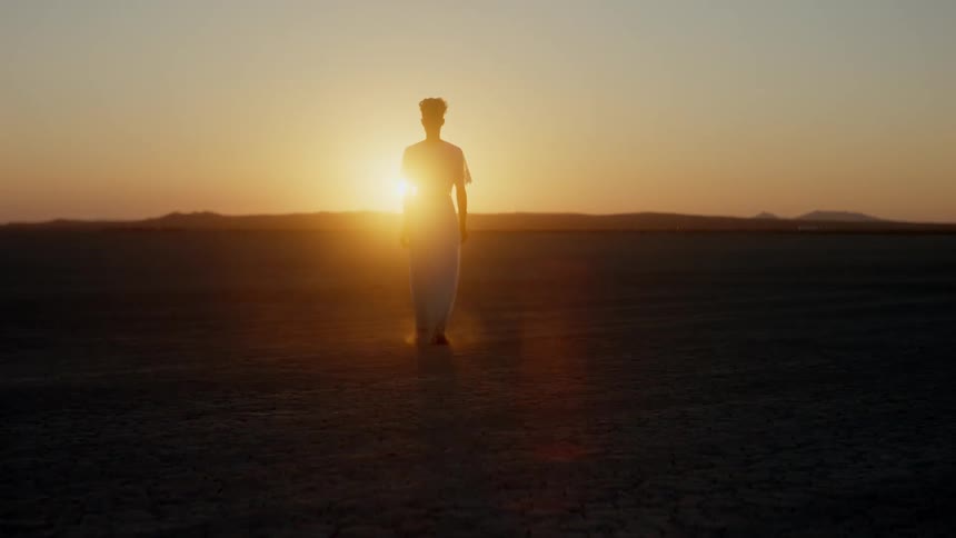 A woman is walking in the desert