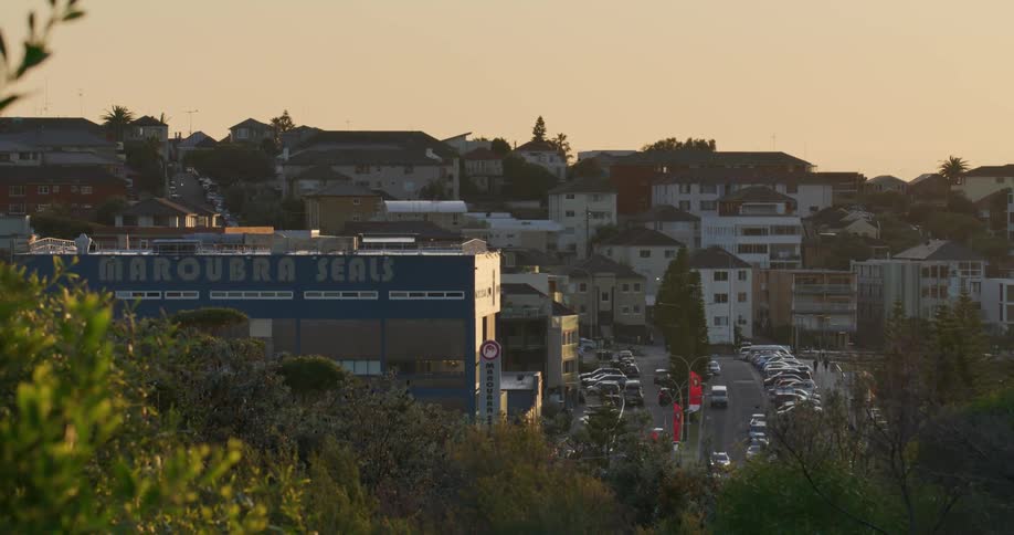 Panoramic view of vehicles driving on the road of a city at evening