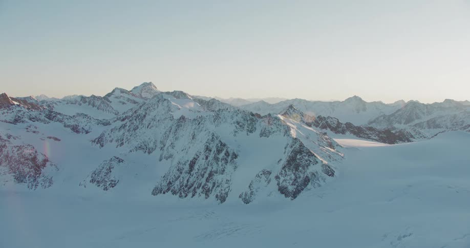 A snow covered mountain range during the day
