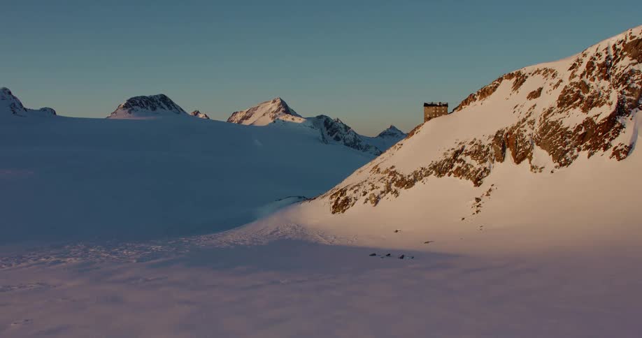 A building sits in a mountain range