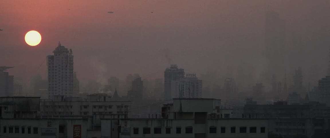 Spaceships flying high above the buildings of this city at dawn