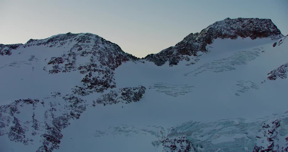 A snow mountain range at dawn