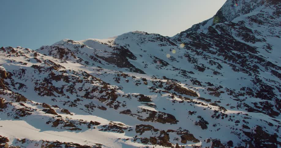 A snow covered mountain range during the day