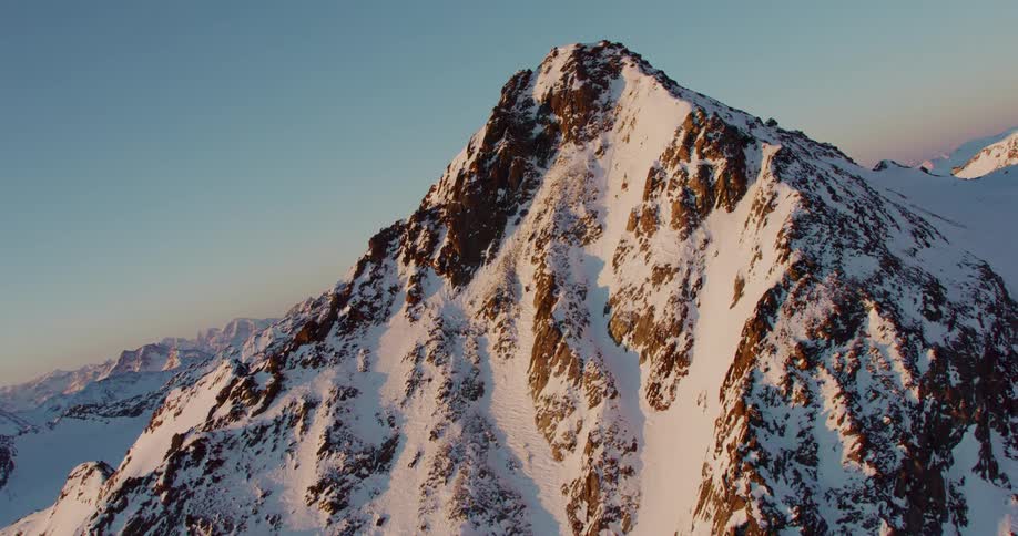 A vast mountain range is covered with a blanket of snow