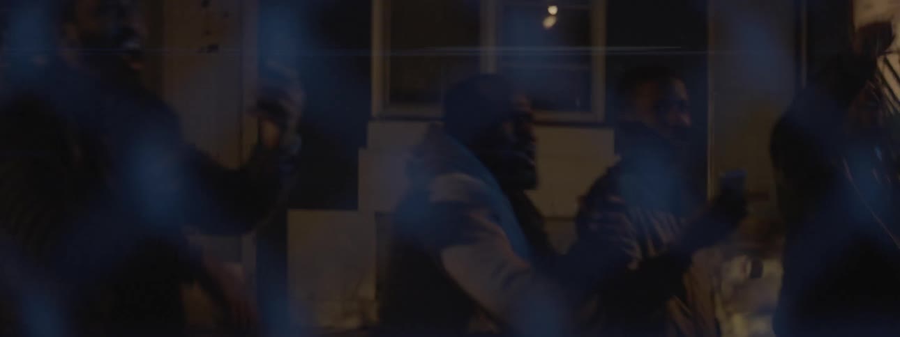 People rioting outside a house at night