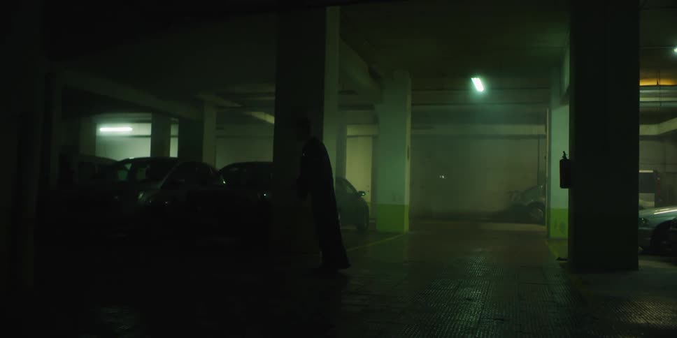 A man stumbles through the dark parking lot