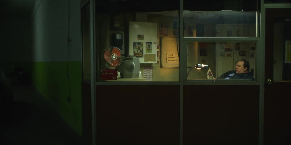 Man sits in an office drinking from a mug