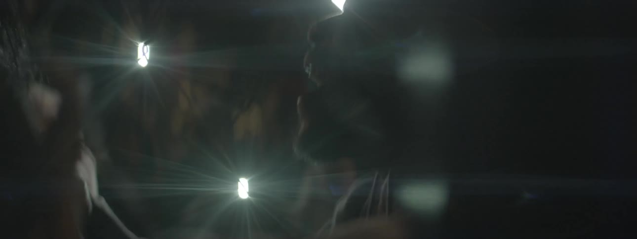 Flashing lights in the dark and a crowd of people