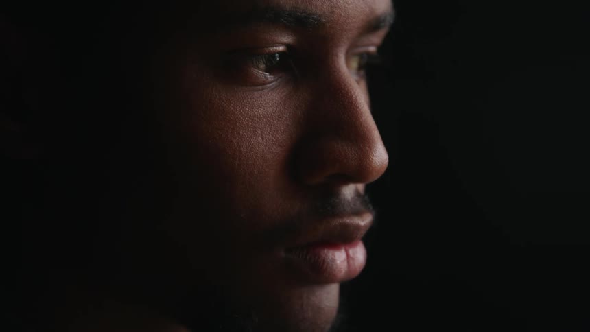 Man concentrates downward before raising his head
