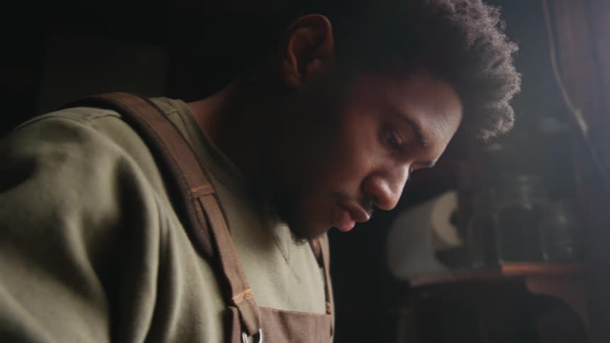 A tradesman works in his shop