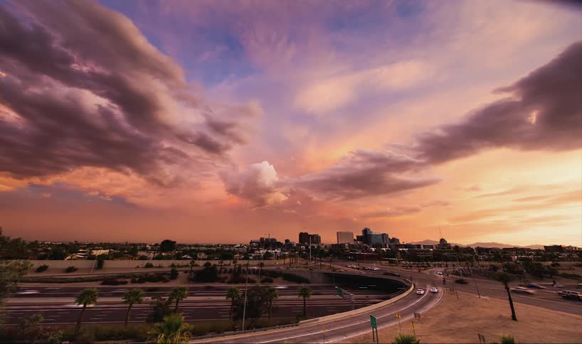 Time-lapse of traffic with dark clouds forming overhead