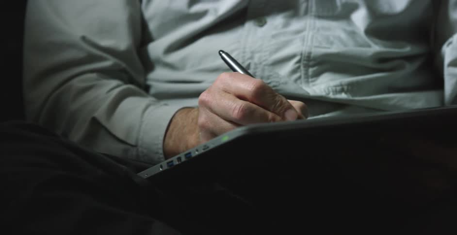 A man drawing on a computer graphics tablet