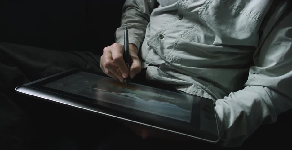A man is drawing on a computer