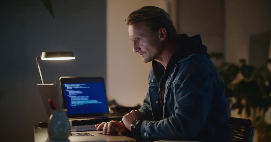 A coder works at his laptop