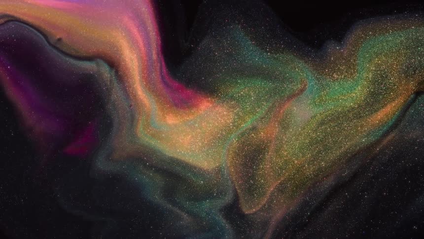 Abstract colors and sparkles moving around slowly on a black screen