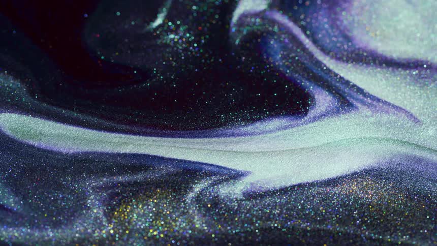 Sparkly gold and silver swirls mixed with white and blue on a black screen