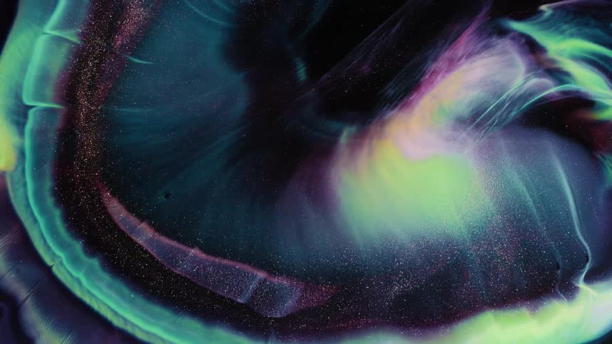 A dark abstract with blue and green colors swirling around on the screen