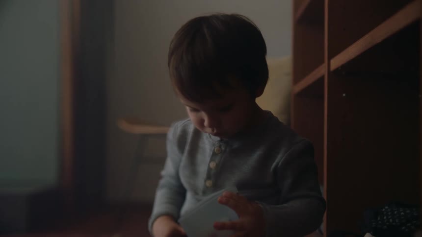 A young toddler is playing in his room in the day time